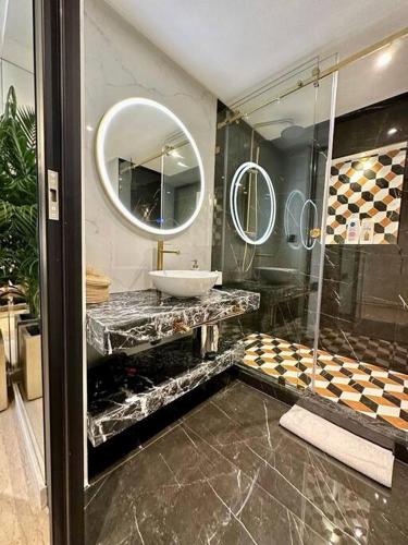 a bathroom with a sink and a mirror at Ultra-Luxury 2-Bedroom Apartment in City Center Atlas View in Marrakesh