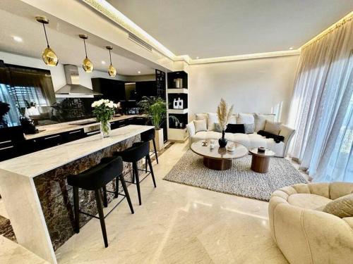 a living room with a kitchen and a living room with a table at Centre Zara 2BR in Marrakech