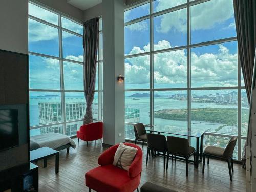 a room with a large window with a view of the ocean at Top Sea View - Maritime Suite 只有海景房 in Jelutong