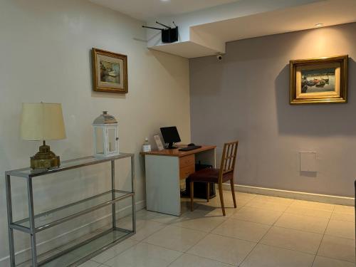 a room with a desk with a computer and a chair at Hotel Centro Naval in Buenos Aires