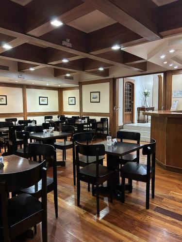 a restaurant with tables and chairs in a room at Hotel Centro Naval in Buenos Aires