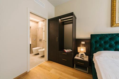 a bedroom with a large bed and a bathroom at Palazzo Confalonieri da Lisca in Verona