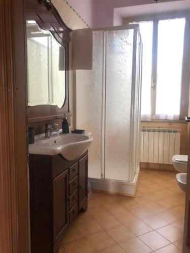 a bathroom with a sink and a shower and a toilet at AL CASTELLO Cengio Alto in Cengio