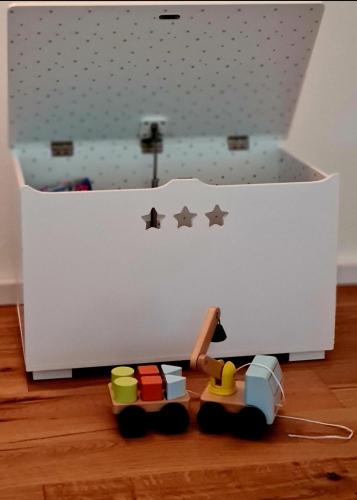 a toy train in front of a white box at Muota River Loft & Muota Industry Apartment near Stoos in Muotathal