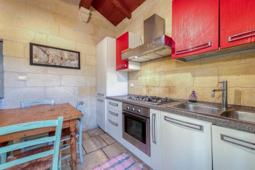 a kitchen with a sink and a stove and a table at Masseria Copertini in Vernole