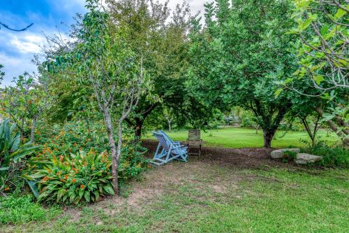 a blue chair sitting in a yard under trees at Masseria Copertini in Vernole