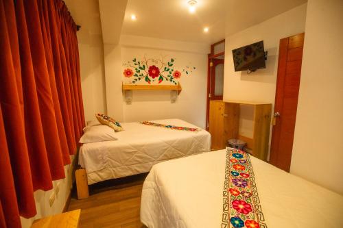 Postel nebo postele na pokoji v ubytování Hotel Ruta Amazónica Machupicchu