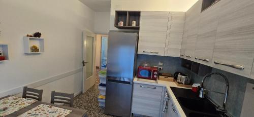 a kitchen with a stainless steel refrigerator in a room at Ca' Olivo in Mogliano Veneto