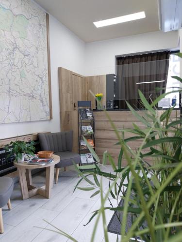 a room with a couch and a map on the wall at Hotel Zelený potok in Pec pod Sněžkou