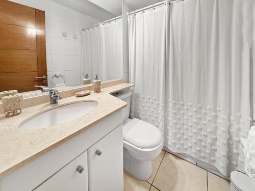 a bathroom with a sink and a toilet and a shower at Marbella Country Club in Maitencillo