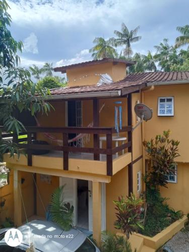 a view of a house with a balcony at SUITES E CHALES PRIVADOS Rock's&Rose's home in Camburi