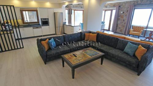 a living room with a couch and a coffee table at Villa Torba Bay by EvTatilim in Torba