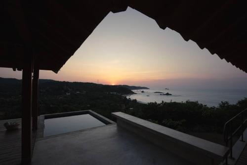 a sunset from a house with a view of the ocean at Casa Queña, in the heart of Mazunte in Mazunte