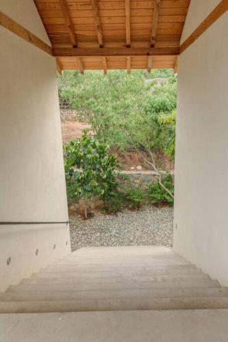 an open porch with a view of a garden at Casa Queña, in the heart of Mazunte in Mazunte