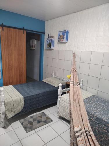 a room with two beds in a room at Cantinho especial in Recife