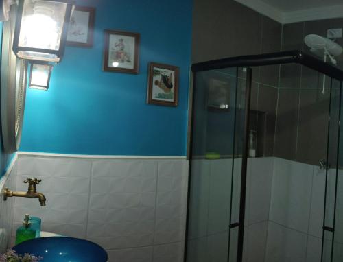 a bathroom with a shower and a toilet and a sink at Cantinho especial in Recife