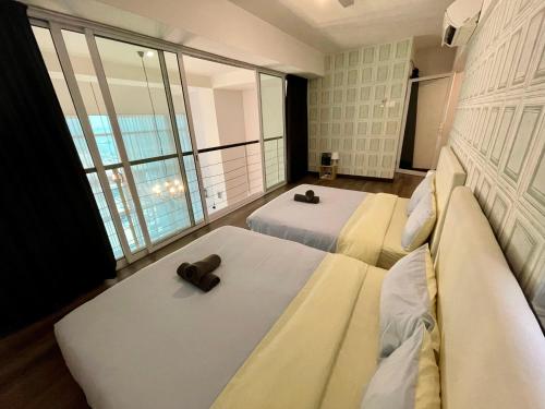 a hotel room with two beds and a large window at Top Sea View - Maritime Suite 只有海景房 in Jelutong