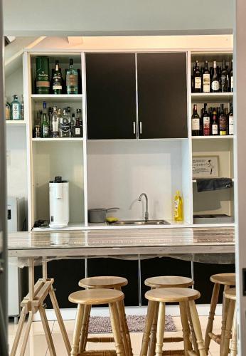 a kitchen with a counter with stools in it at Top Sea View - Maritime Suite 只有海景房 in Jelutong