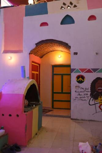 a room with a wall with a dog house in it at Bob Marley Guest House in Aswan