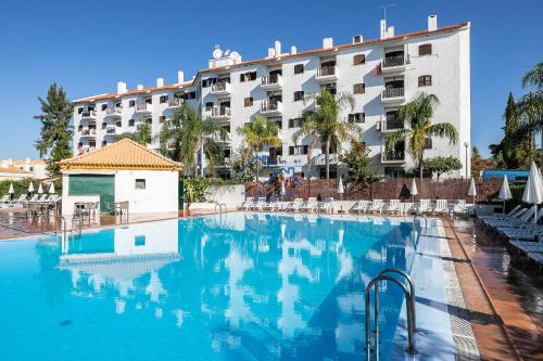 a swimming pool in front of a hotel at Casa das Casinhas by East Algarve Guest in Tavira