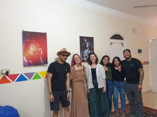 a group of people posing for a picture in a room at Bob Marley Guest House in Aswan