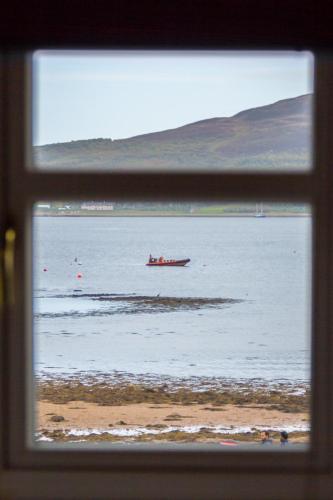 a view from a window of a boat in the water at Lamlash Bay Hotel in Lamlash