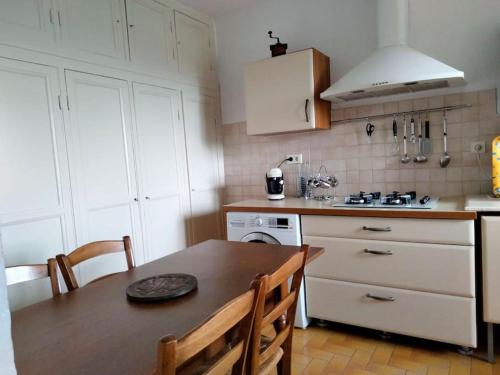 une cuisine avec une table et une cuisinière four supérieur dans l'établissement Maison de village corse, à Campitello