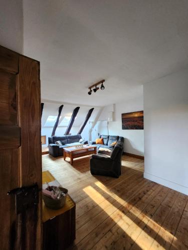 a living room with two couches and a table at Hof KuMa in Uelzen