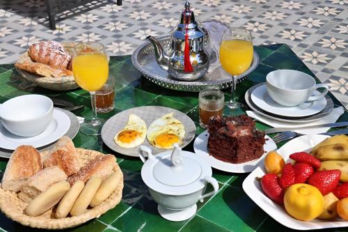 a table with breakfast foods and drinks on it at Villa Le Belvedere in Tangier