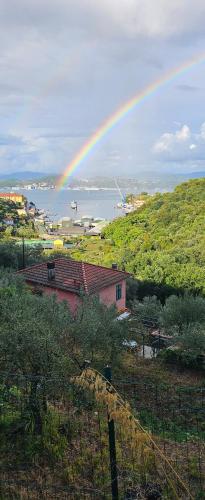 a rainbow in the sky over a body of water at CASA AMELIA in Le Grazie