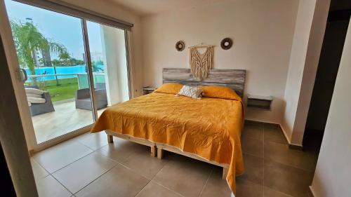 a bedroom with a bed and a large window at Dreams Lagoon in Cancún
