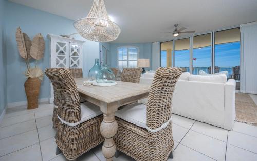 a dining room with a table and a couch at FL-Beach Colony East E3B condo in Pensacola