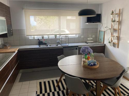 eine Küche mit einem Holztisch und einem Waschbecken in der Unterkunft Oliveira House in Ponta Delgada