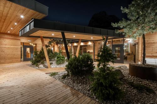 a house with a courtyard at night at Hotel Majon Miramonti in Canazei