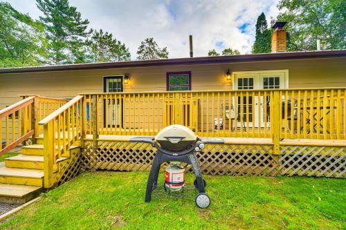 a stroller parked in front of a yellow house at Hayward Home with Private Deck, Fire Pit and Kayak! in Hayward