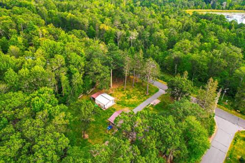 an overhead view of a cabin in a forest at Hayward Home with Private Deck, Fire Pit and Kayak! in Hayward