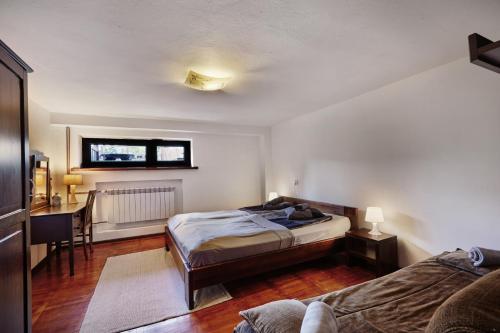 a bedroom with a bed and a desk in it at Dom Kubicowka in Rybarzowice