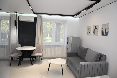 a living room with a couch and a table at Nice and cosy in Arabkir