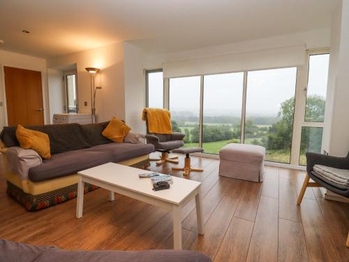 a living room with a couch and a table at Beautiful Cotswold View in Bourton on the Water