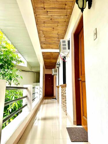 a hallway of a building with a wooden ceiling at Papierus Pensionne in Kalibo
