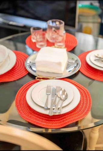a table with red and white plates and silverware at Charming Carmel Suite 8 min to Carmel Arts District in Carmel
