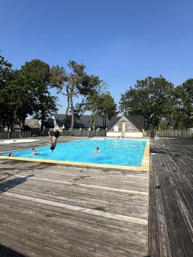 un groupe de personnes dans une piscine dans l'établissement La Maison du Treustel - Combrit - Chez Thomas & Elodie, à Sainte-Marine
