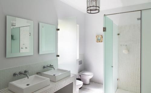 a bathroom with two sinks and a toilet at 22 Van Wijk Street Tourist Accommodation in Franschhoek