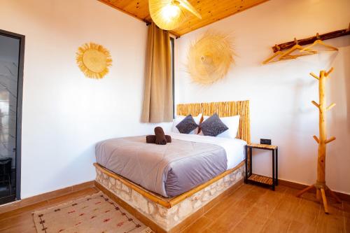 a bedroom with a bed in a room at Smaylo Surf House in Sidi Kouaki