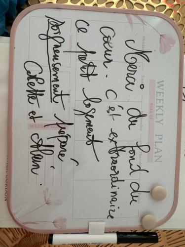a piece of paper with writing on top of a clipboard at Apartment La Viarhôna à Brégnier-Cordon in Brégnier-Cordon