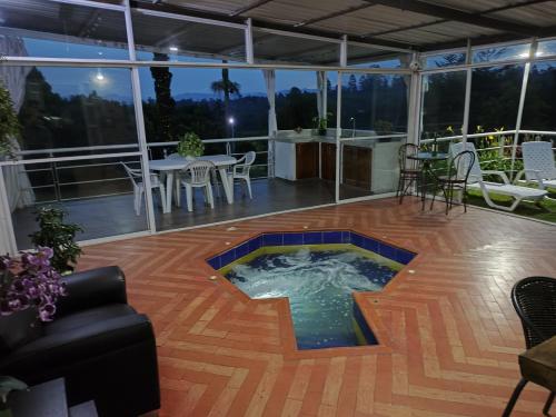 a hot tub on the deck of a house at Orion Luxury Lodge in Calibío
