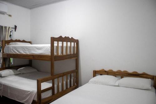two bunk beds in a room with white walls at Villas Julie in Tela