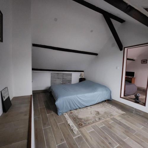 - une chambre avec un lit et un miroir à l'étage dans l'établissement Maison Bourgogne, à Château-Chinon