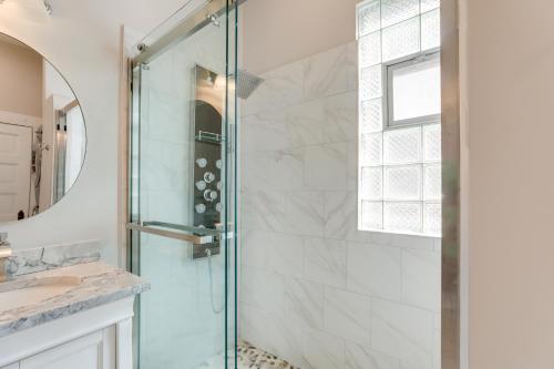 a shower with a glass door in a bathroom at Spacious Chicago Condo with Deck Less Than 9 Mi to Downtown! in Oak Park
