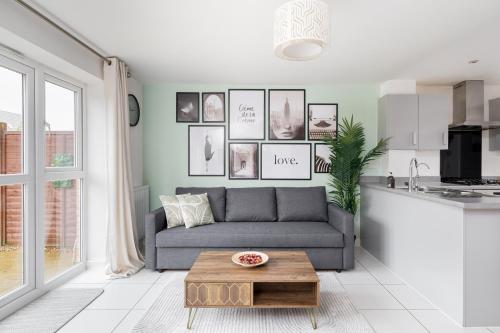 a living room with a couch and a coffee table at 4 Bedroom House By Humming Nest Short Lets & Serviced Accommodation Milton Keynes With Free WiFi & Parking in Milton Keynes